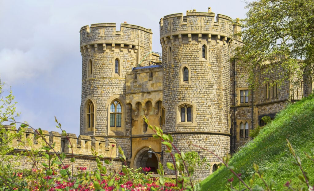 Windsor castle in the summer with flowers in the foreground.