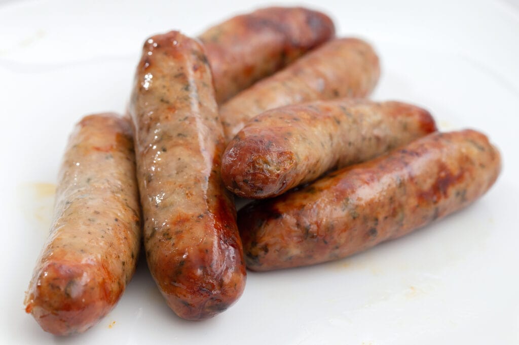 British Lincolnshire pork sausages cooked on a white plate