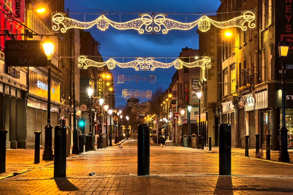 Christmas lights on empty Henry Street in the early morning 