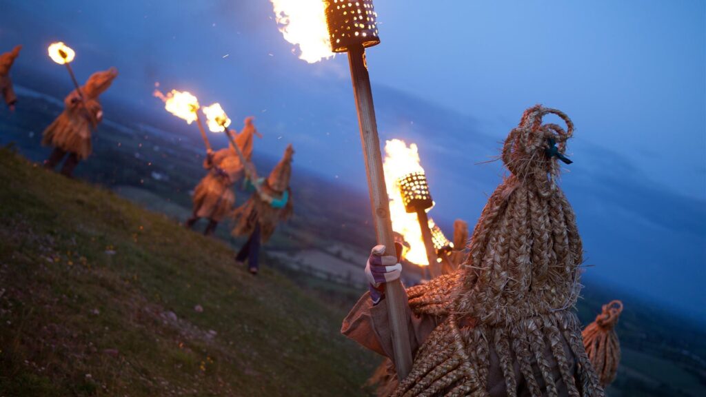 Irish folklore tells tales of the mummers who celebrate the pagan ritual of the winter solstice. These mummers carry torches at twilight up the hill to light the fires of Beltaine. They are dressed in braided straw garments with cone-shaped masks. 
