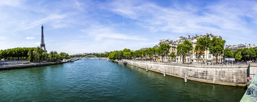 Cityscape of Paris with view at Eiffel tower - the Seine river and residential buildings