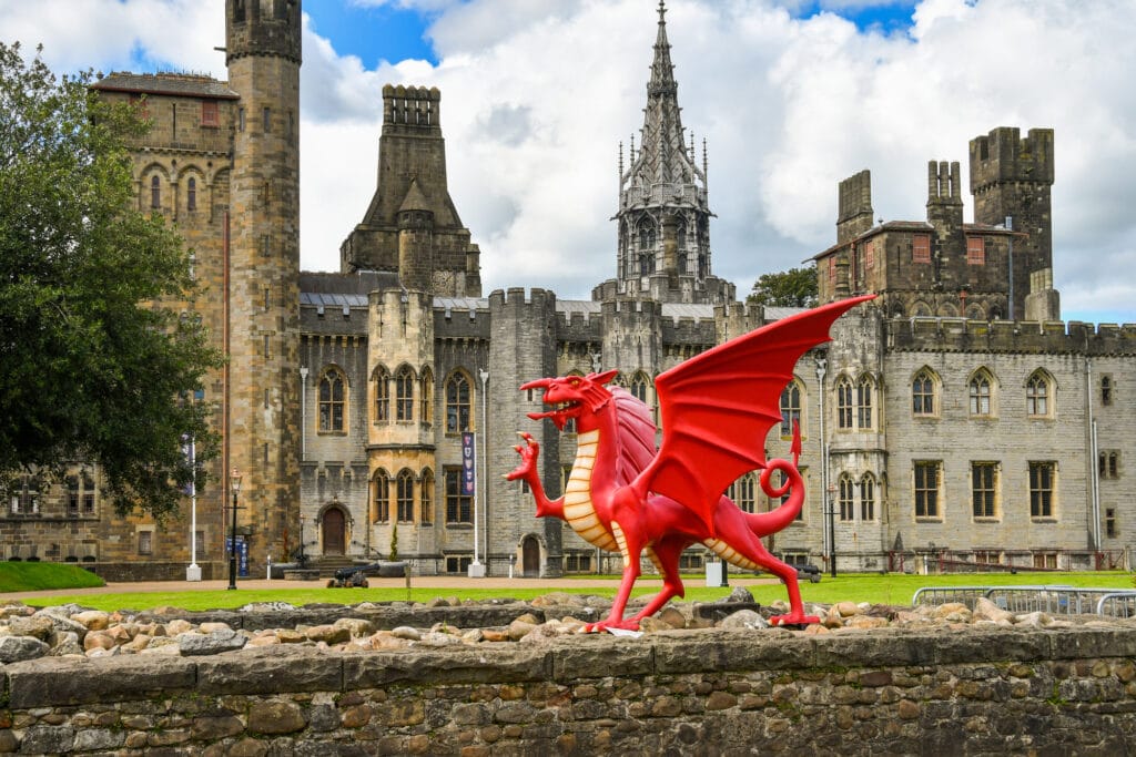 Cardiff, Wales a large model red dragon sits on the walls of the  Cardiff Castle - best Castles in Wales