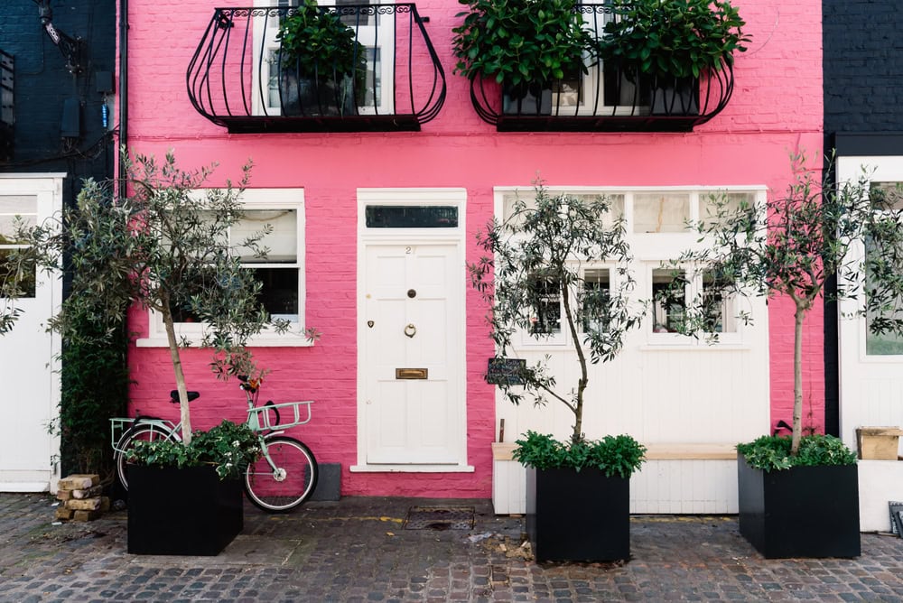 London, UK - May 15, 2019: Pink color painted house in St Lukes Mews alley near Portobello Road in Notting Hill