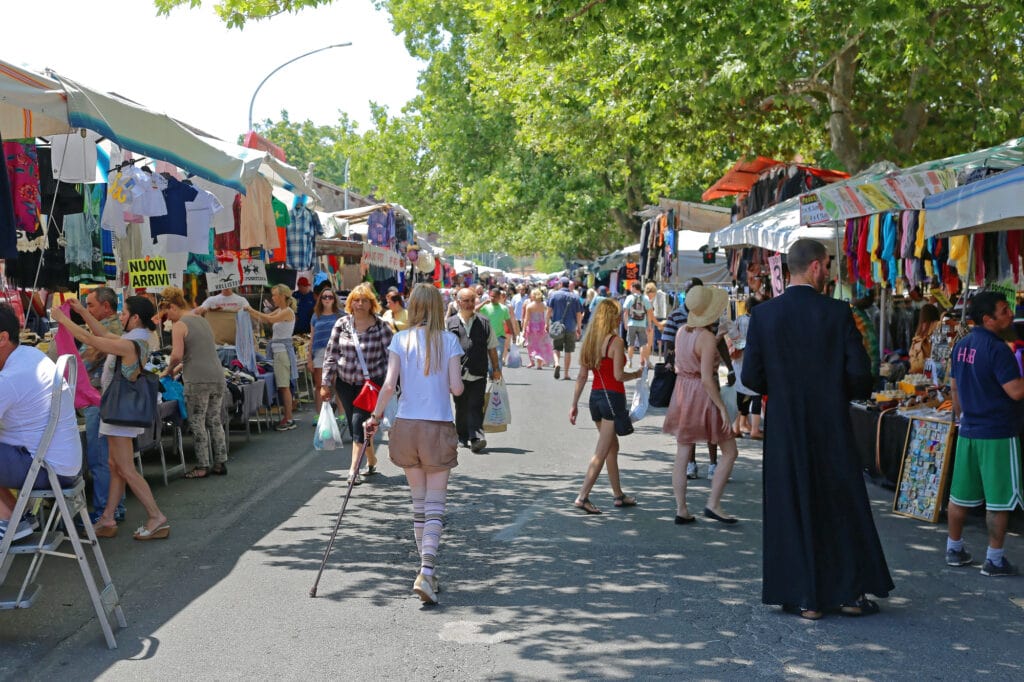 ROME, ITALY - JUNE 29, 2014: People Browsing For Knick Knacks at Porta Portese Sunday Flea Market in Rome, Italy.