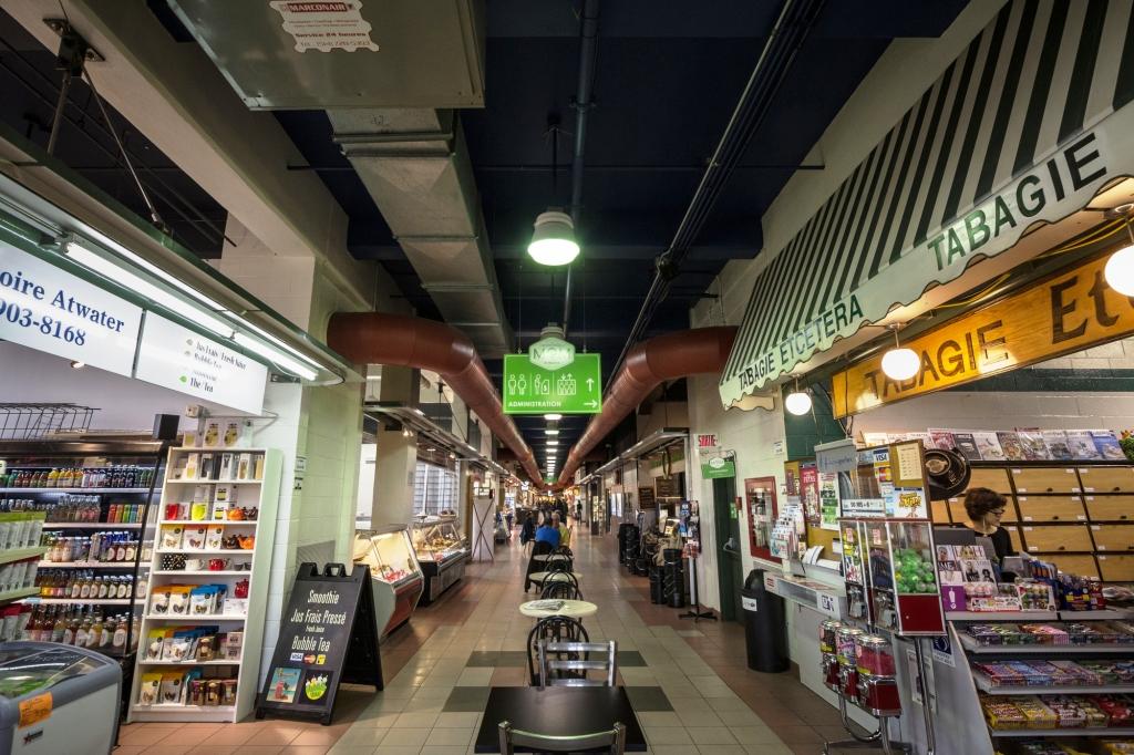 MONTREAL, CANADA - NOVEMBER 6, 2018: Main alley of the interior of Marche Atwater market, in Montreal, Quebec. it is one of the main public markets of Montreal, and a landmark of the city

Picture of the inside of Atwater market in Montreal, Quebec, Canada, with people passing by in the inside of the main building, in the main alley. Atwater Market is a market hall located in the Saint-Henri area of Montreal