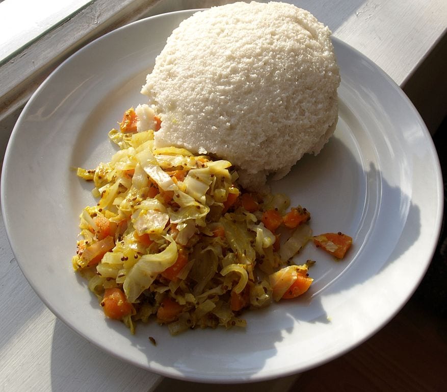 Shaped like a large dumpling you pull pieces of the dough off and use it to scoop up stews or it is placed in the centre of a bowl and then stews are spooned on top of the Ugali dumpling