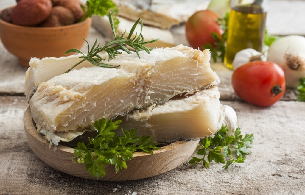 salted codfish on the wooden table with ingredients