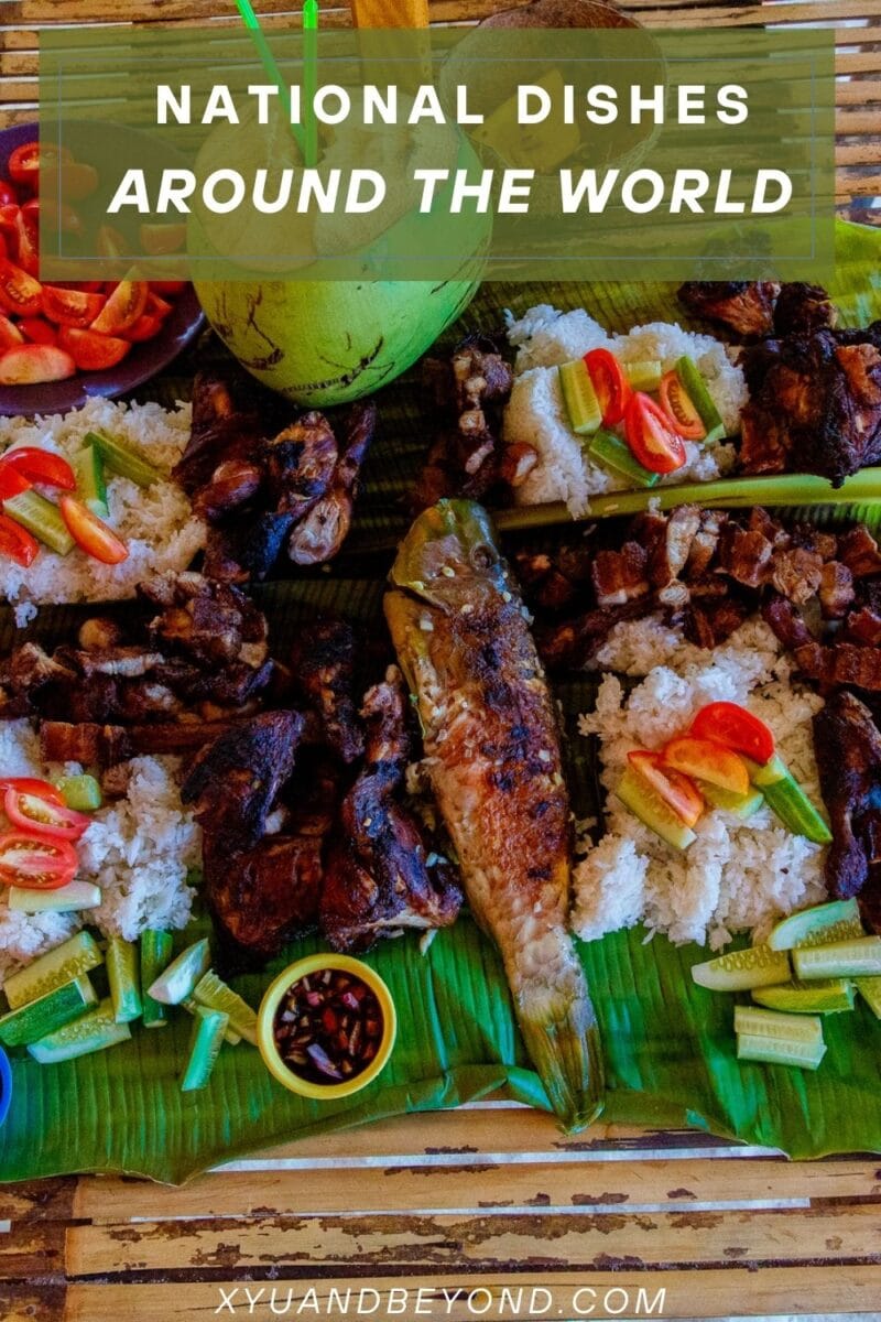 A variety of national dishes from around the world presented on a bamboo mat, featuring national dishes such as grilled meats, rice, vegetables, and a globe centerpiece.