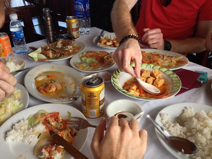 A group of people exploring the world of food, eating delicious dishes at a table.