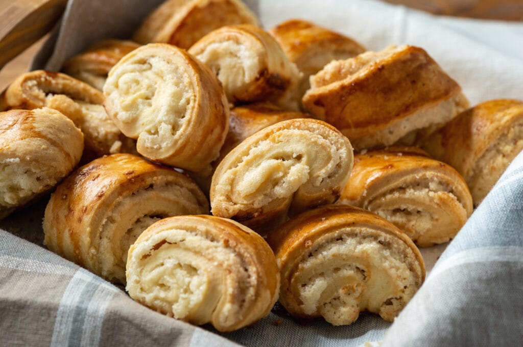 Armenian croissants in a basket on a wooden table.