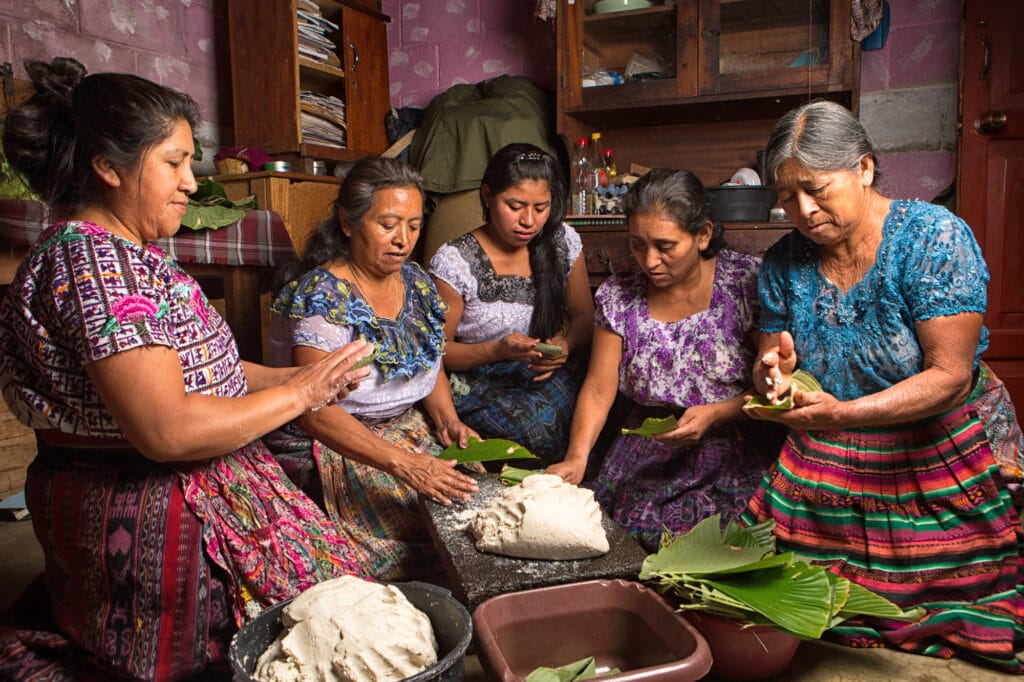 January 20, 2015 San Pedro la Laguna, Guatemala: tzutujil mayan women preparing traditional food together