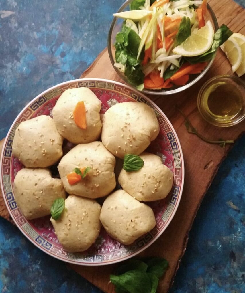 Armenian fried dumplings on a plate with a salad on the side.