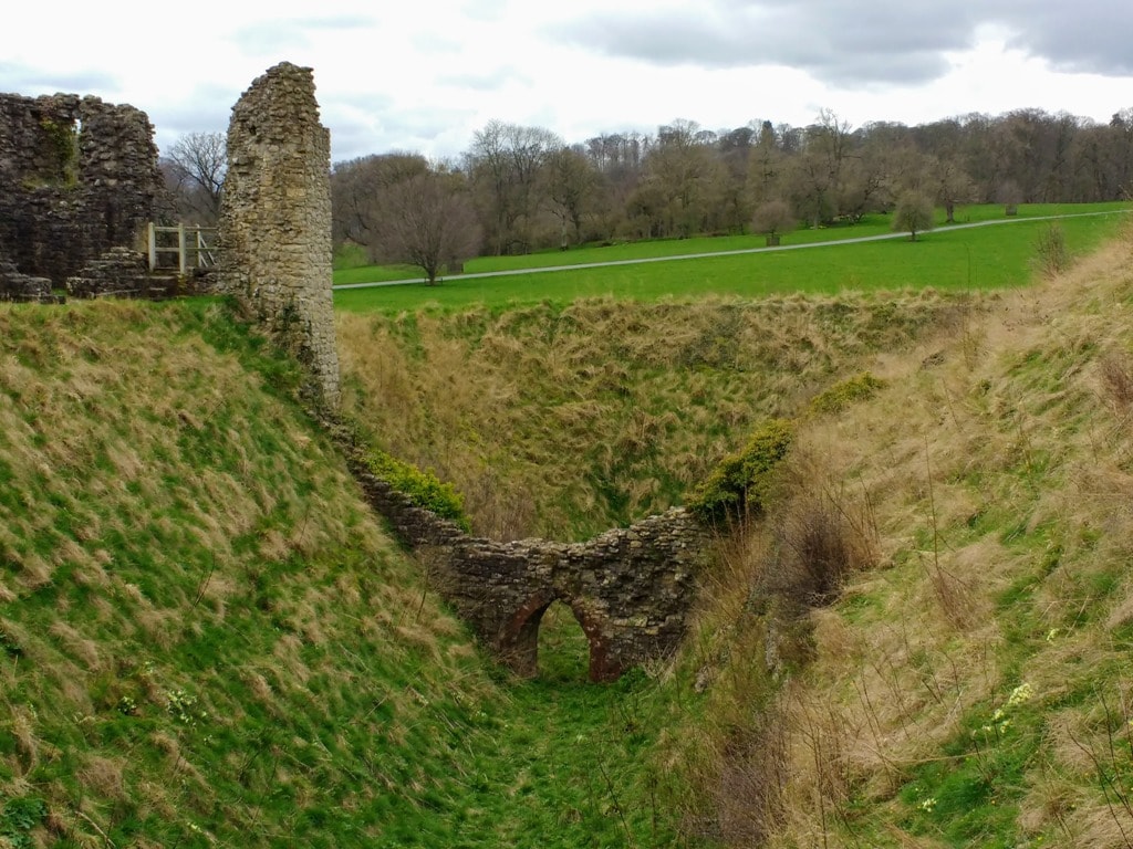 Ditch that used to surround the Helmsley Castle in Yorkshire with the remains of the ancient stone bridge to get to the castle