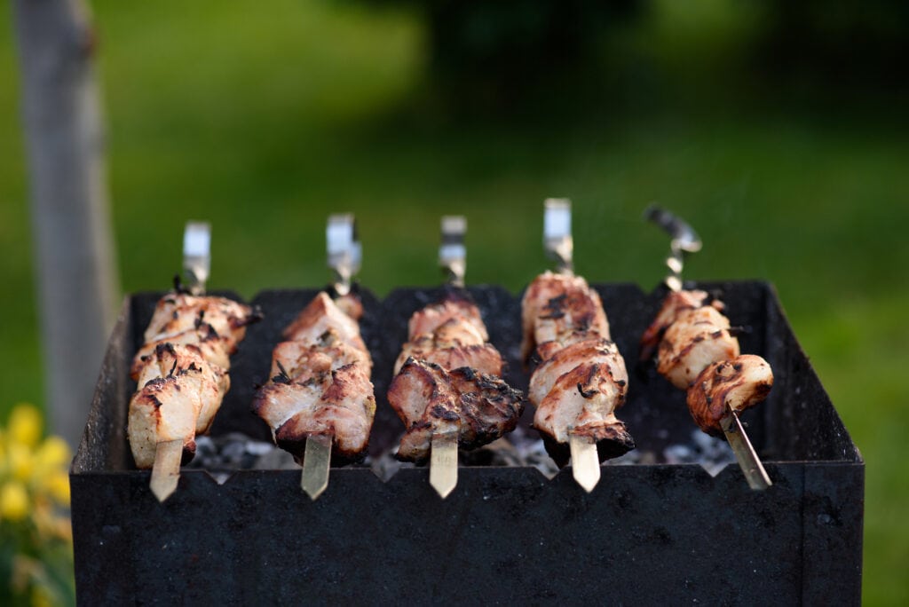 Grilling Marinated Shashlik On A Grill. Shashlik Is A Form Of Shish Kebab  Popular In Eastern, Central Europe And Other Places. Shashlyk (meaning  Skewered Meat) Was Originally Made Of Lamb. Royalty Free