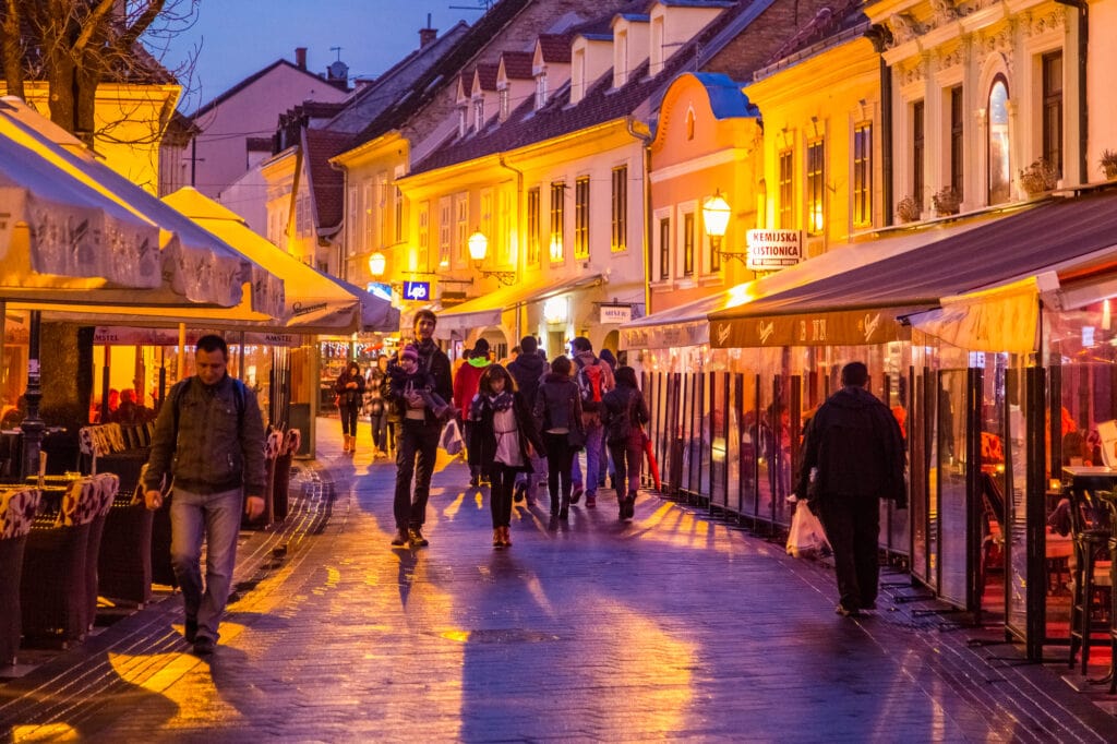 ZAGREB, CROATIA - View of Tkalciceva ulica at dusk with locals and tourist walking in between bars and cafes. food of Croatia