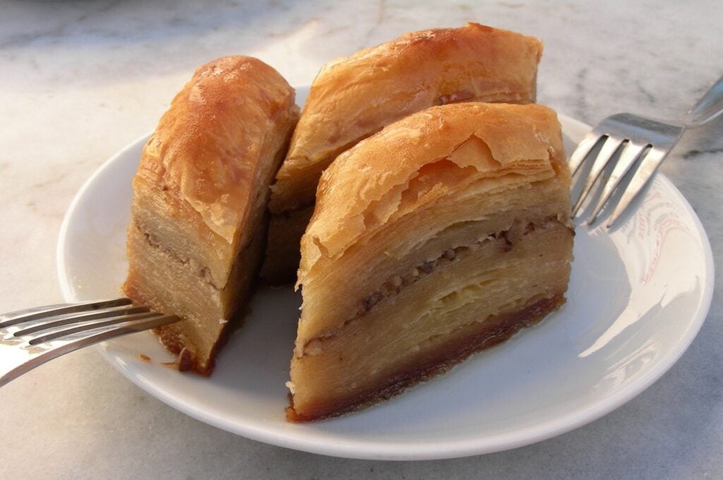 A plate with a fork and a piece of Lebanese baklava.