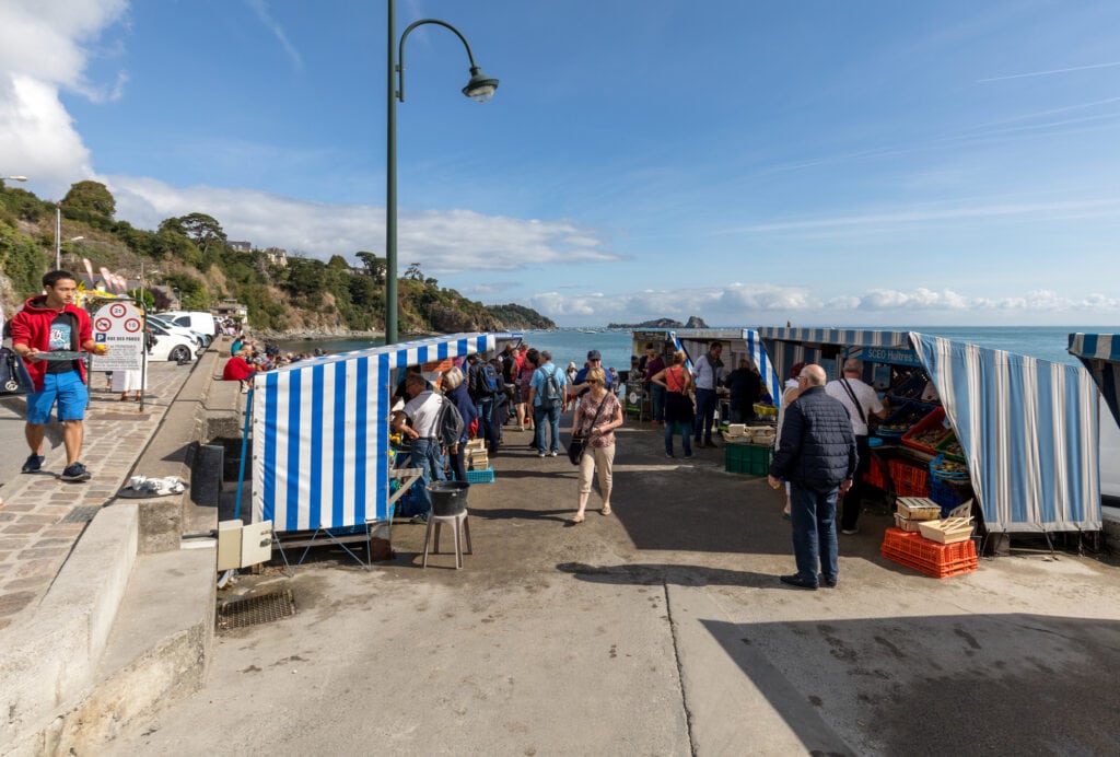 Cancale, France - September 15, 2018:Tourists visit a farm for harvesting oysters along with a small market for selling them for consumption in Cancale, France,