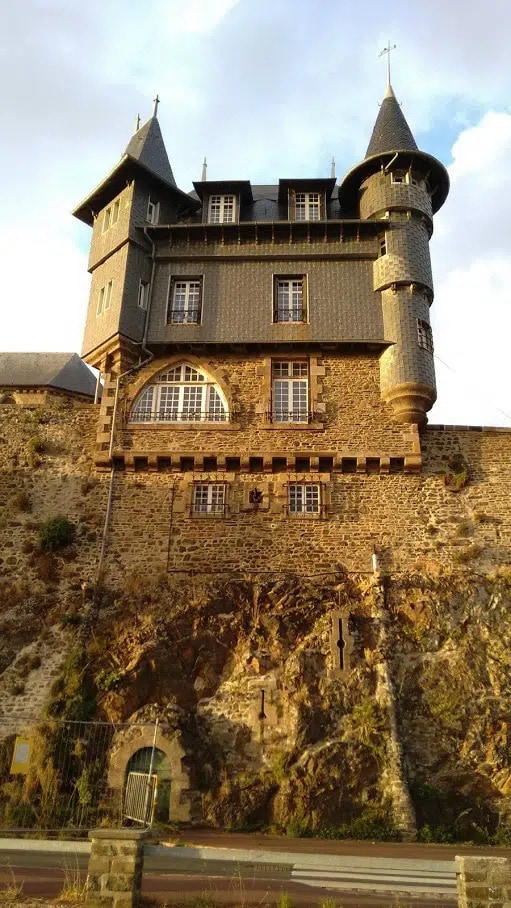 A medieval stone house used as a lookout tower in Granville France. The house is constructed from the cliff side up into a sonte and tile covered building.