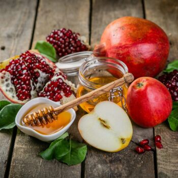 Honey and pomegranate on a wooden table.