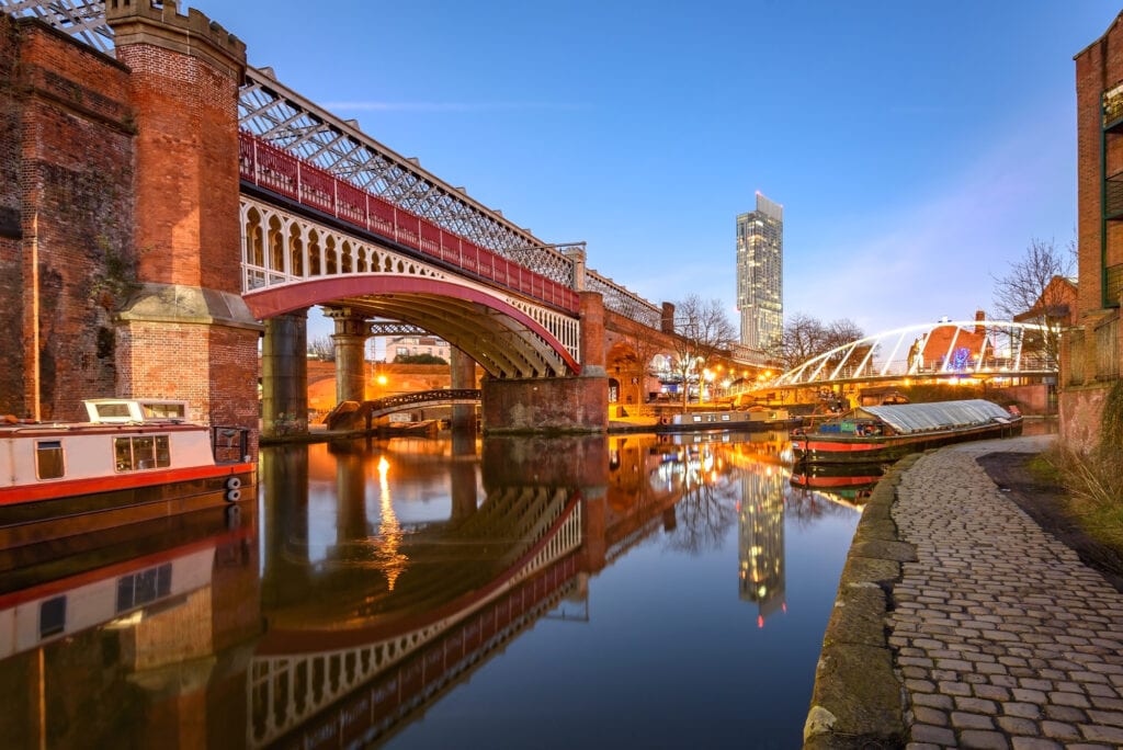 View of Manchester tallest building Beetham Tower, reflecting in Manchester Canal.