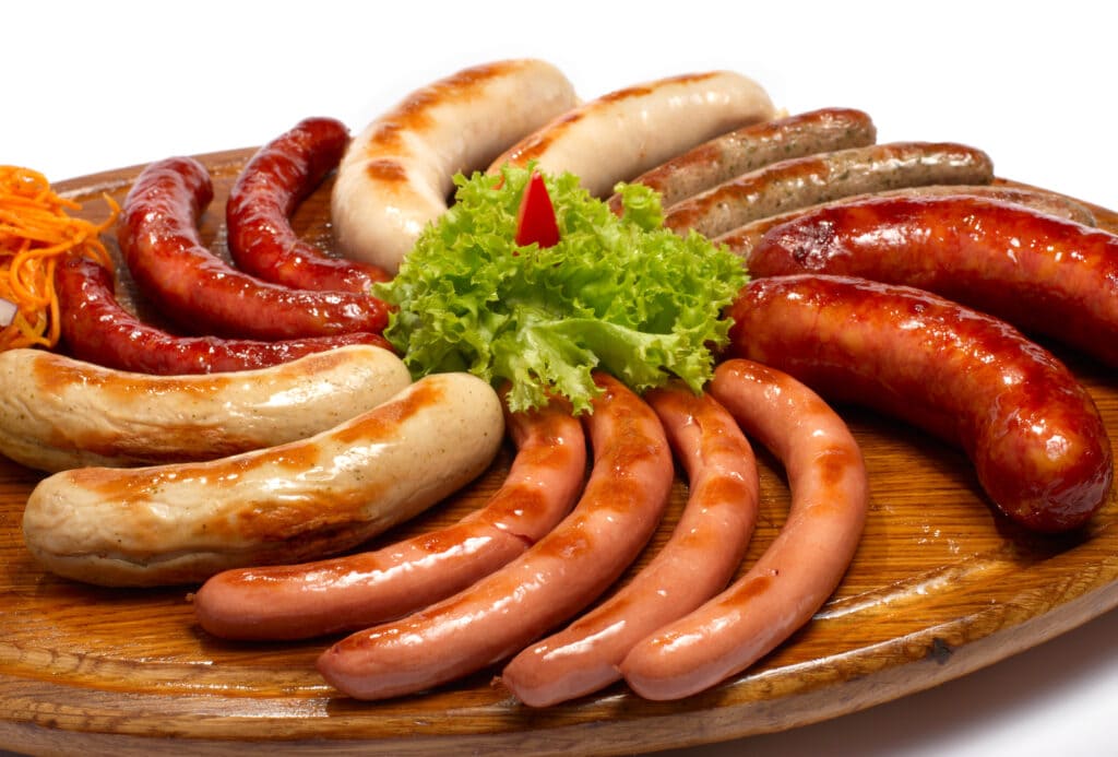 A set of different sausages, grilled on wooden plate types of sausage around the world