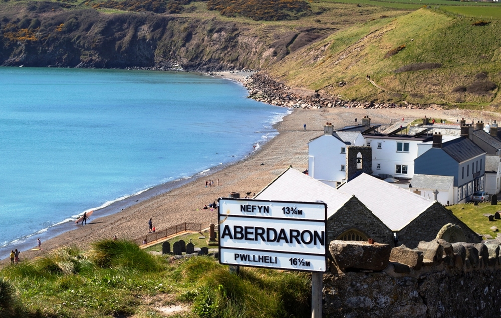 Aberdaron, Wales Beautiful landscape of the village, bay, sea and dramatic cliffs Small seaside resort with a quiet secluded beach with blue sea lapping on the sandy shore