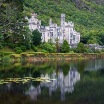 Kylemore Abbey in Connemara, County Galway, Ireland with reflections in the Pollacapall Lough. Kylemore Abbey is a Benedictine monastery founded in 1920 on the grounds of Kylemore Castle.