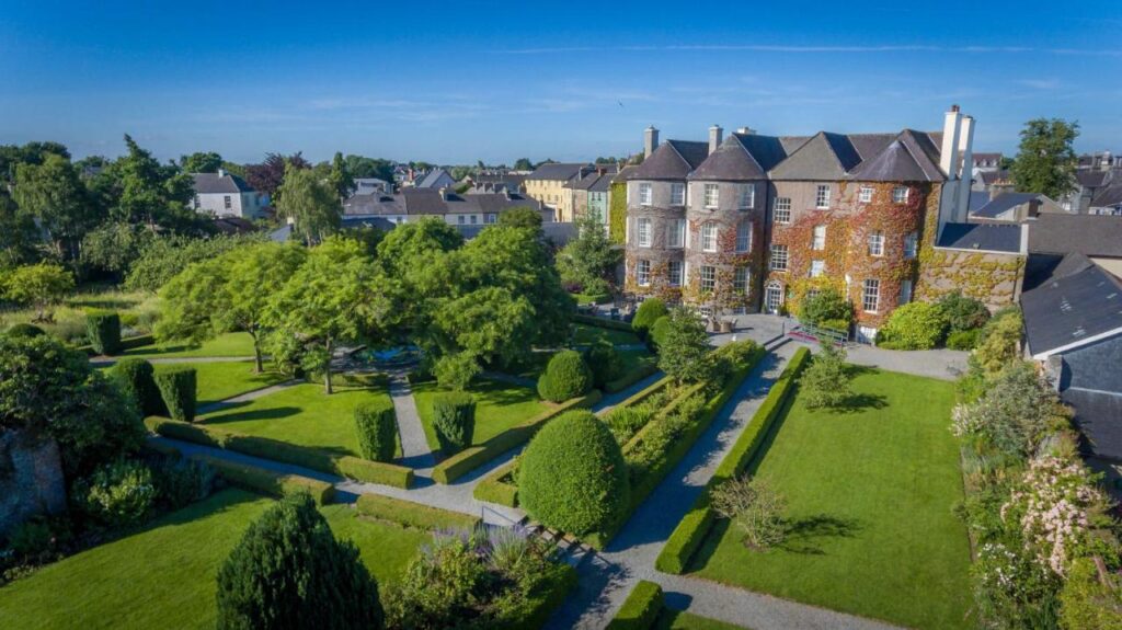 Butler house a beautiful english style mansion from above with the green lawns and gardens