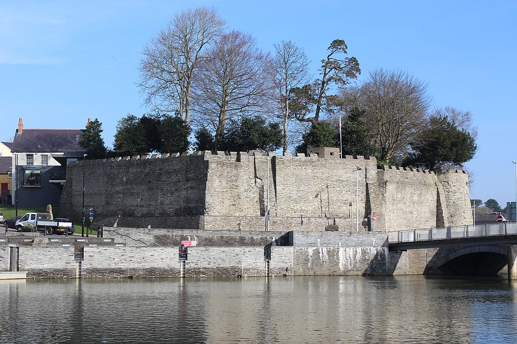 Cardigan Castle in grey stone on the river banks