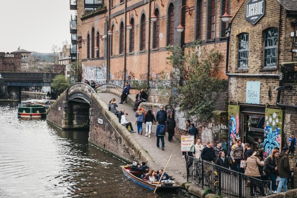 People walking alongside Regent's Canal near Camden Market, London, UK.