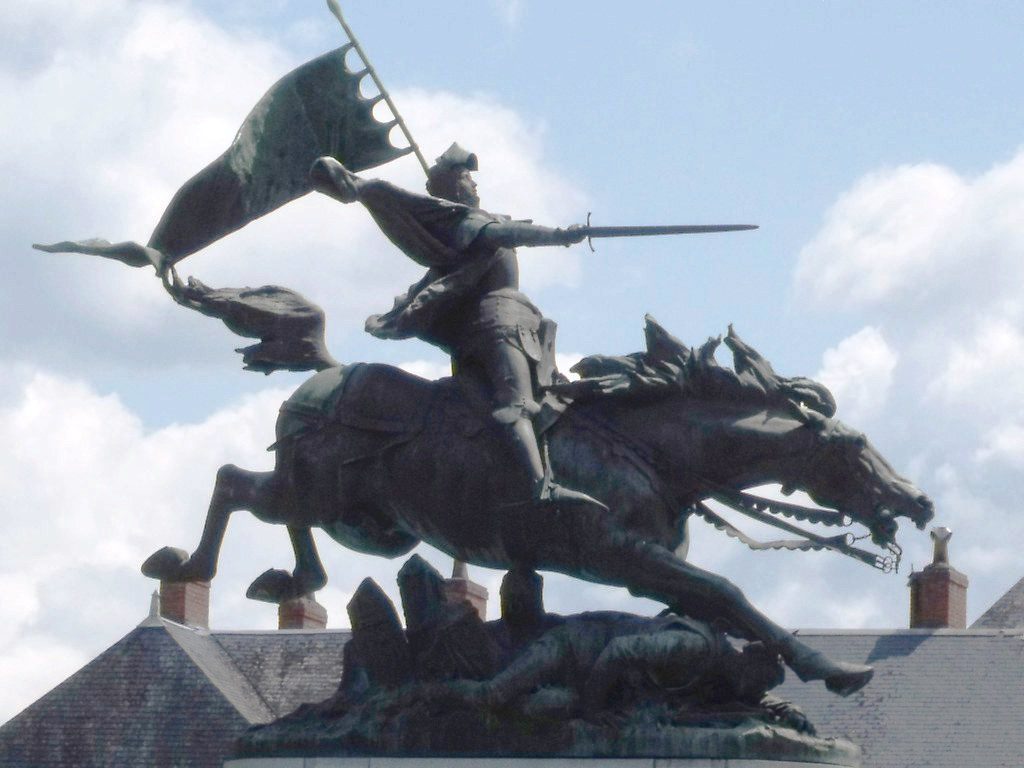 A joan of Arc Statue with Joan riding a horse into battle