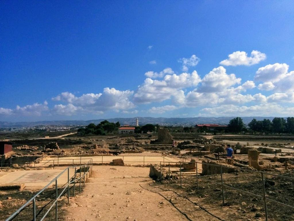 Paphos Archaeological Park Cyprus. A view of the site where you can see the Troodos mountains in the background and the lighthouse in the foreground are the various ruins of Roman occupation