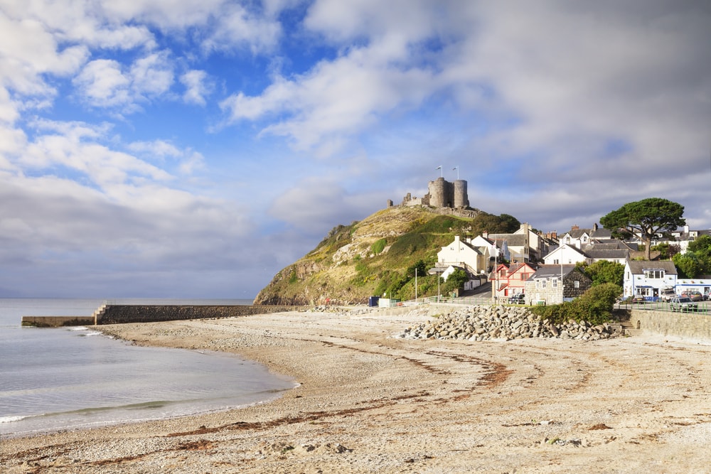 The town and castle of Criccieth, North Wales, on a bright summer day with clearing weather.