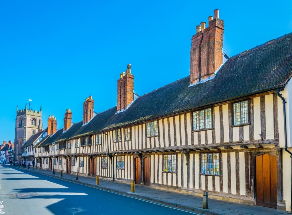 View of the Guildhall in Stratford upon Avon, England. A long half-timbered building dating back to the 15th century
