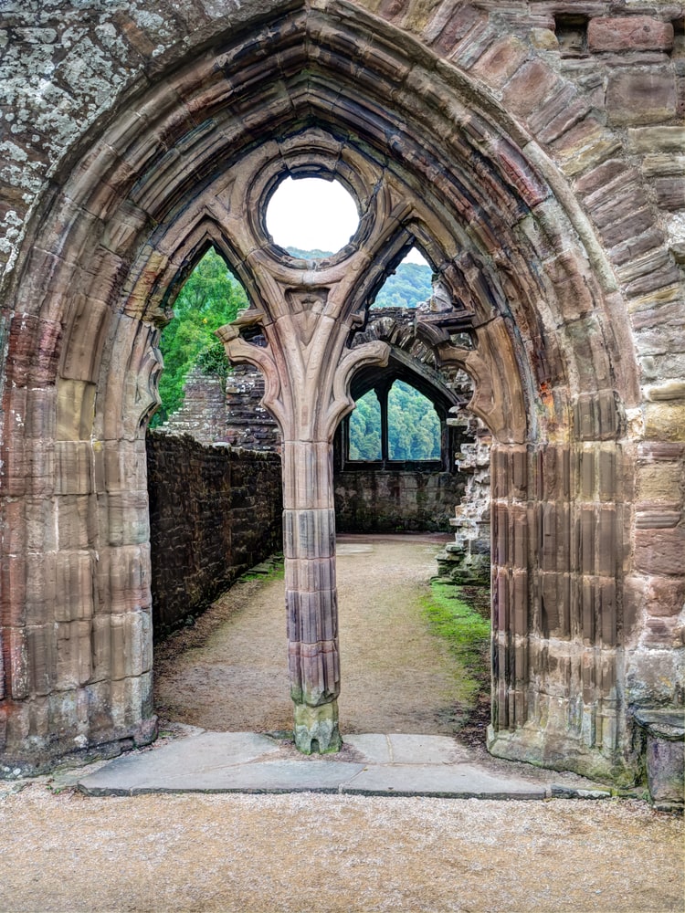Arched doorway inside the ruins of Tintern Abbey in Wales  on the banks of the river Wye close to the English border