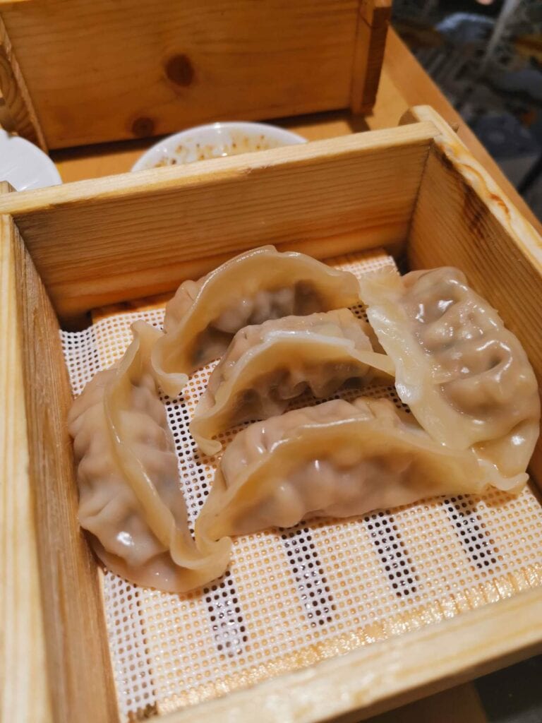 Jiaozi are dumplings mostly filled with ground meat or vegetables and are steamed in big bamboo baskets. Most of the time they are accompanied by a dip made of oil and spices, but in some parts of China, jiaozi is served in a soup.