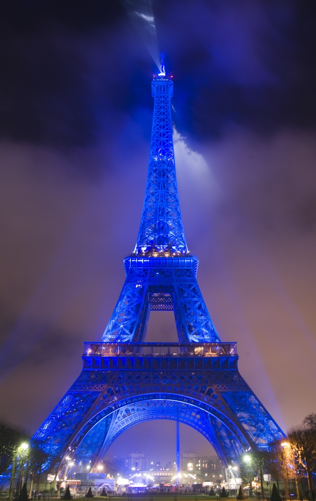 Famous Eiffel tower in Paris. The tower is lit with blue lights to celebrate Christmas in France