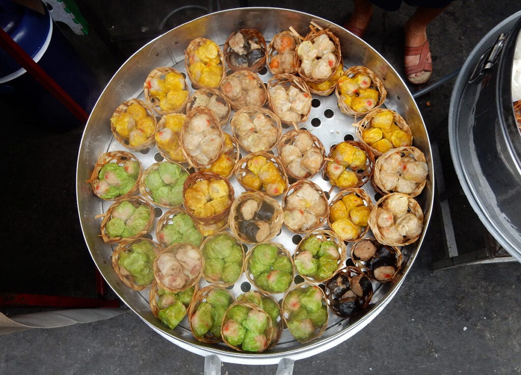 traditionally as street food, they will be found at roadside steaming trays set over a pan of boiling water with two alternatives of either minced pork or minced shrimp meat set in a wonton wrap and steamed until cooked through.