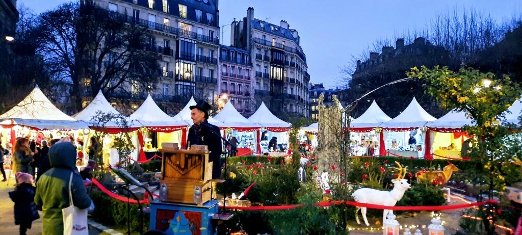 A french Christmas market in Paris with a traditional accordion type of organ