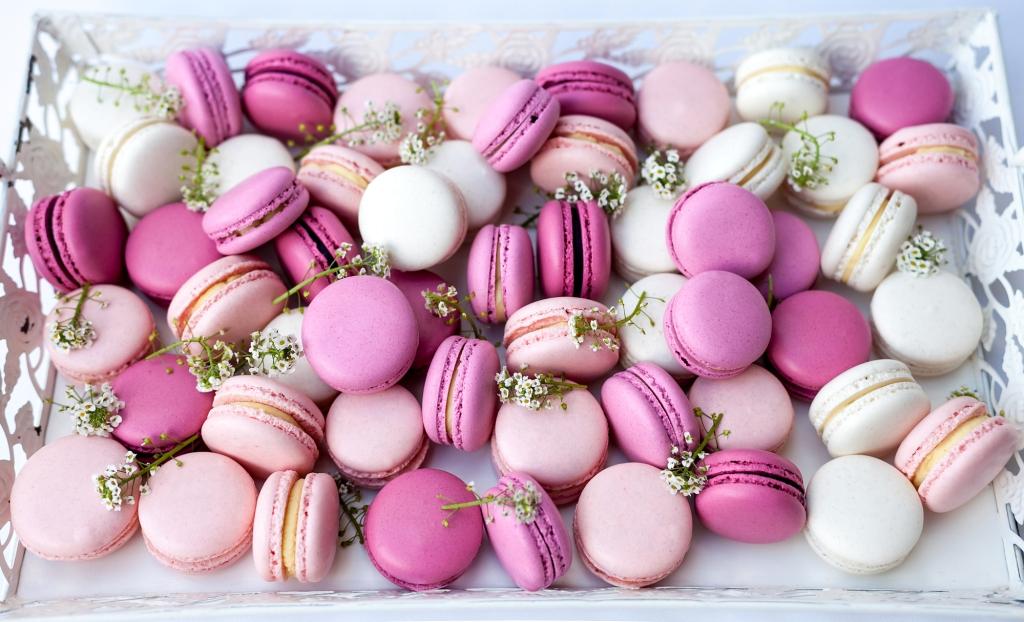 A huge box filled with delicate macarons in purple, and pink with lavender flowers