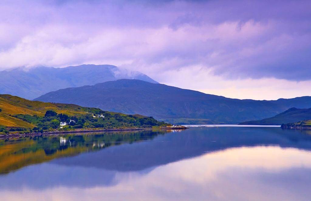 walk on the scenic Connemara loop by Killary Harbour or Fjord at sunset. Touristic, scenic Connemara road on the west coast of Ireland by the Atlantic Ocean among the mountains