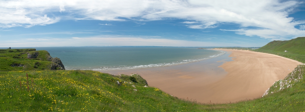 Rhossili Bay in Wales another of the most beautiful beaches along the cost. The sand is pink and the water is a deep grey blue colour