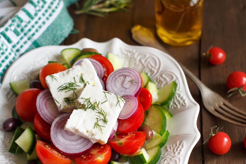 Greek salad with tomatoes, feta cheese, cucumbers, onions and olives
