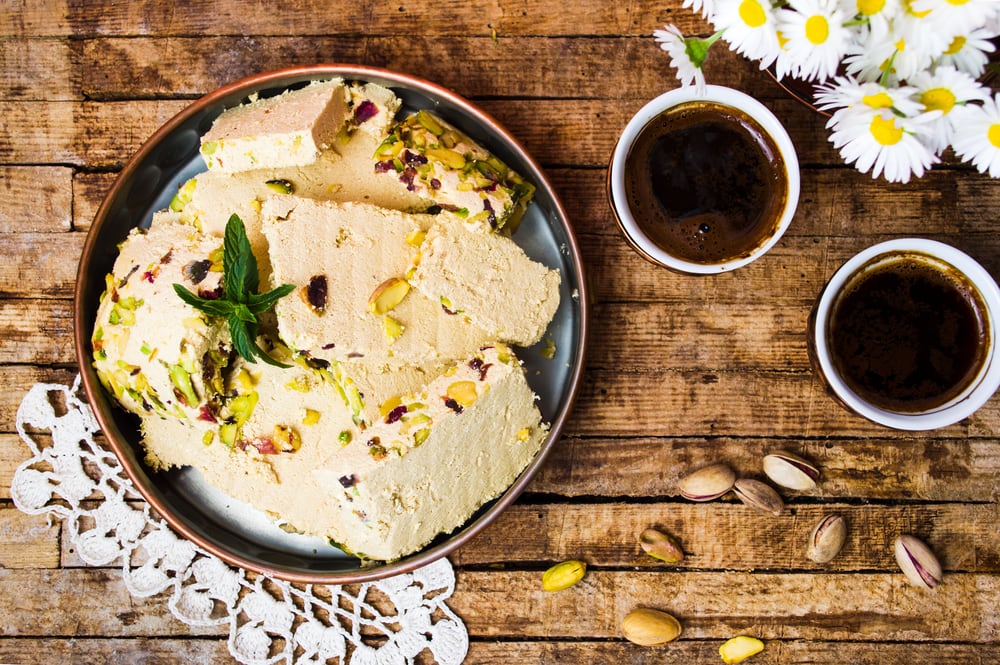 Halva with pistachio served with coffee in copper dish