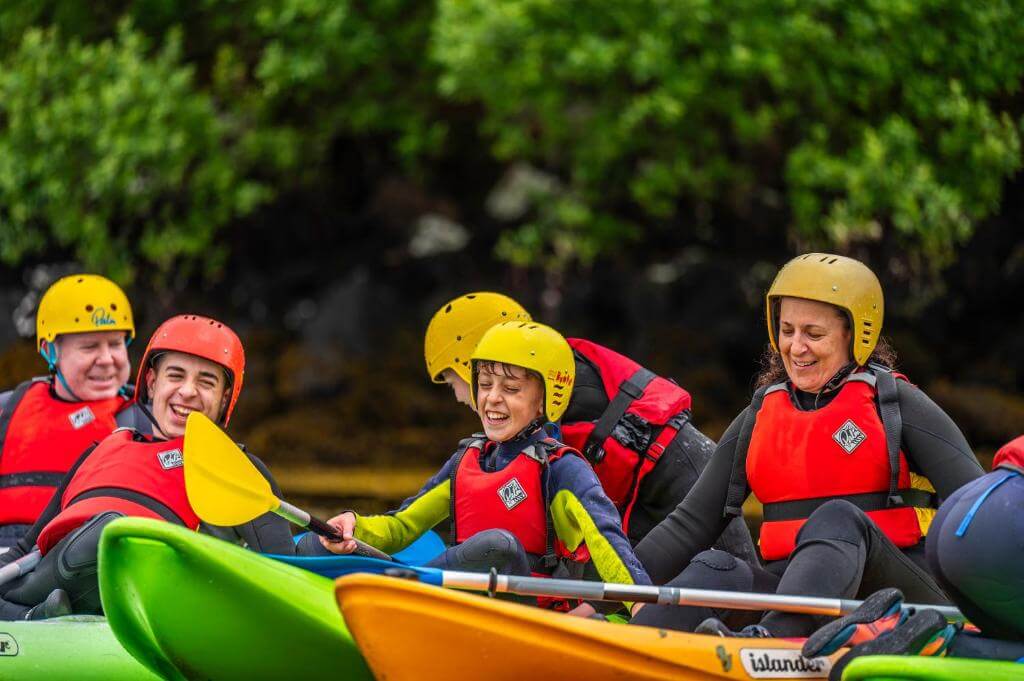Family kayaking in Connemara 3 children and two adults in brightly coloured kayaks in the Killary Harbour