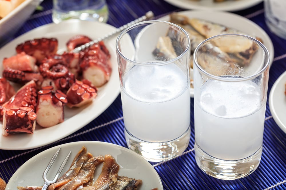Glasses of ouzo and appetizers