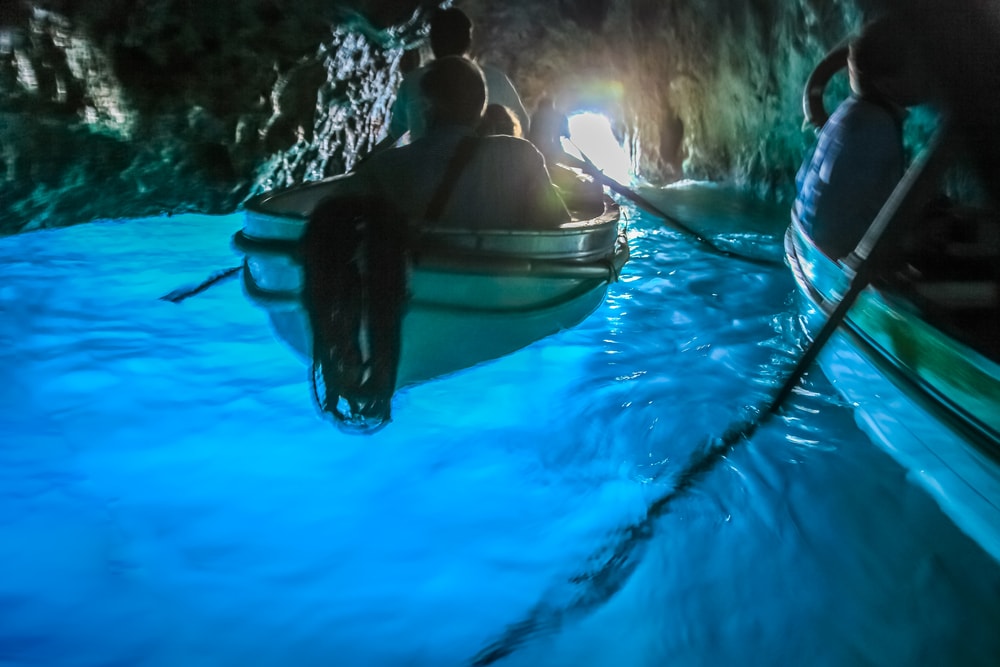 Canoes Inside idyllic turquoise grotto, Capri blue cave, Italy