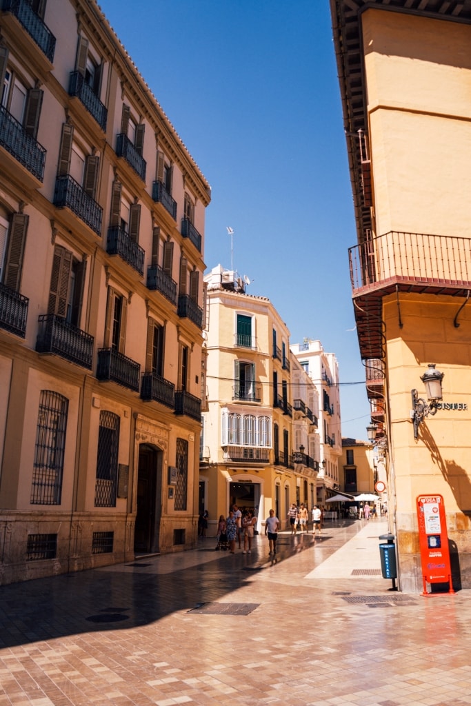 The old streets of Malaga with tiled laneways, pedestrians shopping in the midst of white and cream-coloured colonial style buildings