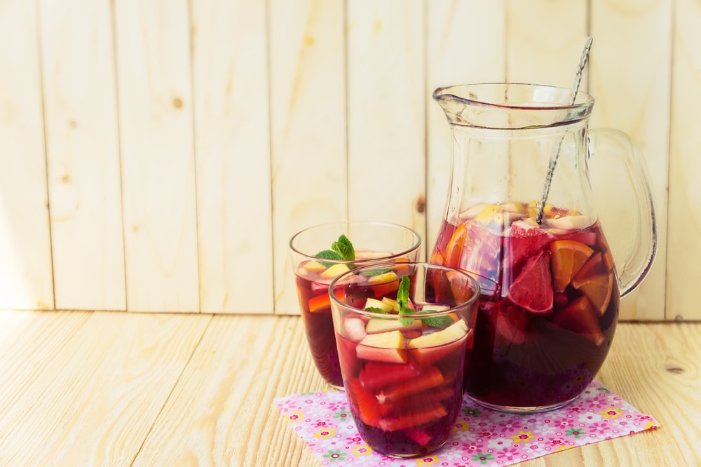 Homemade delicious red sangria with limes oranges, apples and grapefruits
