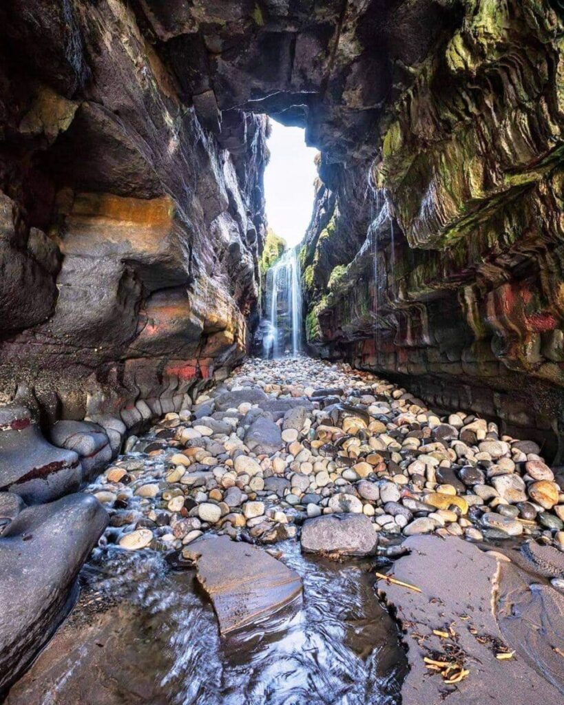 The secret waterfall in Donegal Ireland, the waterfall is in a cave on the wild Atlantic way shoreline